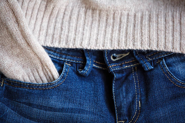 istock Part of blue jeans and woolen pullover close up. 498023790