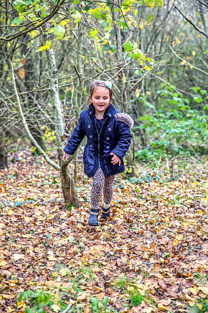 istock Seven year old girl running in woods 498025808