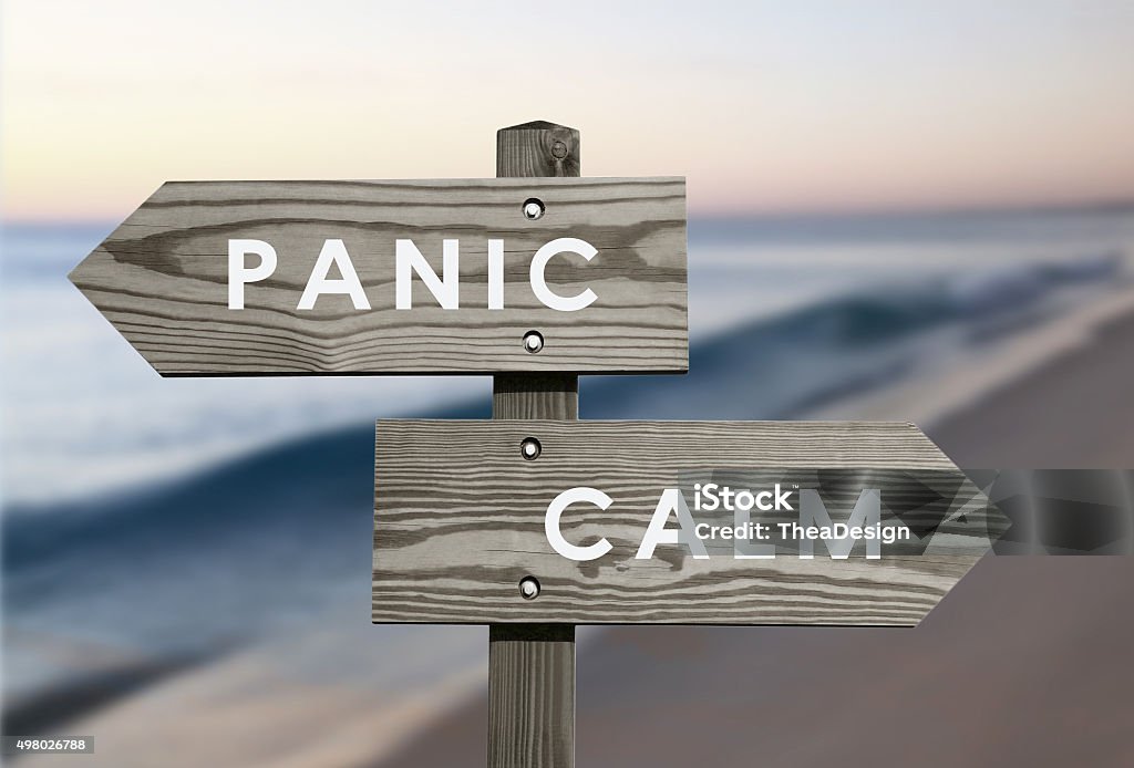 Calm vs Panic Calm vs Panic signs with blurred beach background Control Stock Photo
