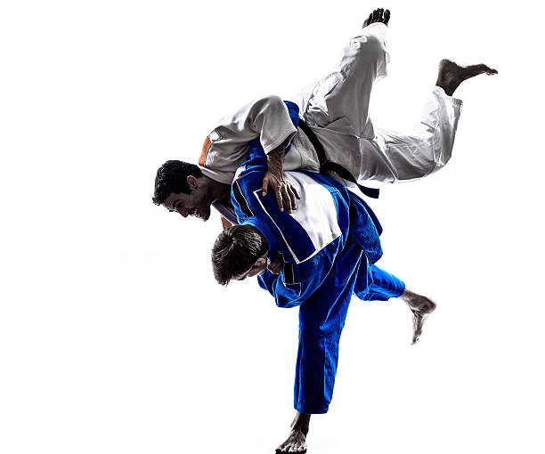 judokas fighters fighting men silhouette two judokas fighters fighting men in silhouette on white background judo photos stock pictures, royalty-free photos & images