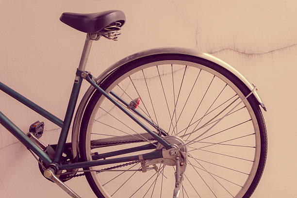 istock Old bicycle leaning against a wall with cracked plaster. 498028981