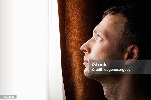 Young Caucasian Man Looking In Bright Window Closeup Profile Po Stock Photo - Download Image Now