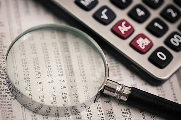 istock Ballpoint pen resting on world currency figures 498030857