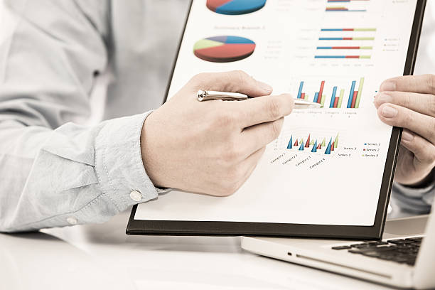 istock Businessman analyzing investment charts with laptop 498031087
