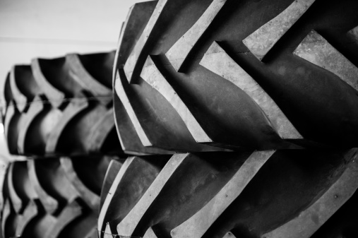 A detail of a row of rubber tractor tires.