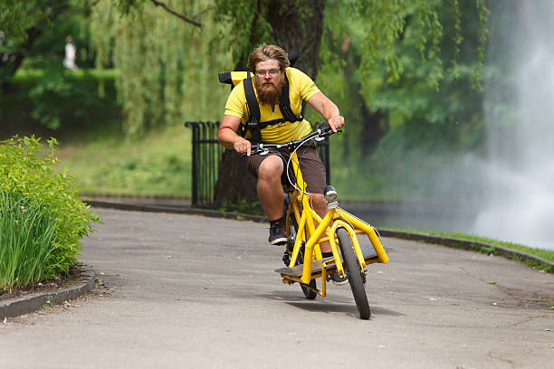 Bicycle messenger with cargo bike speeding Bicycle messenger with cargo bike speeding for delivery cargo bike photos stock pictures, royalty-free photos & images