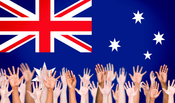 istock Multiethnic Arms Raised and Australian Flag Background 498033335