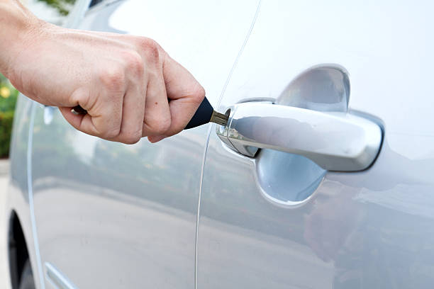 istock hand opening a car door with a key 498033961