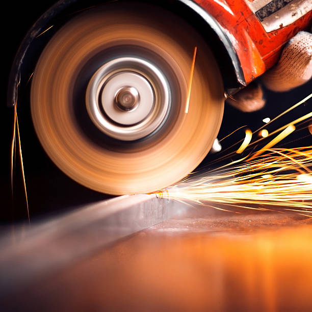 istock Worker cutting metal with grinder. Sparks while grinding iron 498049131