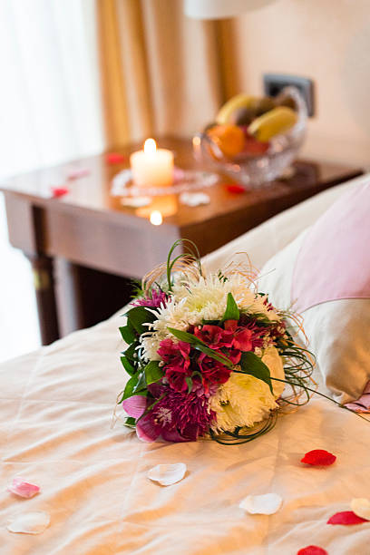 istock Flower bouquet on bed in hotel room 498049158