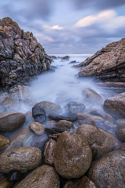 istock Misty waves crashing on the rocks 498049671