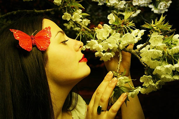 istock Young woman posing with cherry blossom 498050349