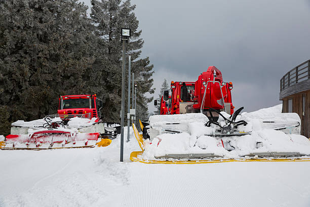 istock Two snowcats parked after fixing snow on ski slope 498051376