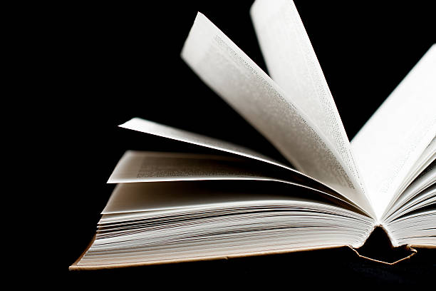 istock Old book on black color background 498051939