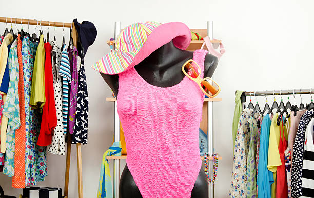 Wardrobe with summer clothes and a beach outfit on mannequin.