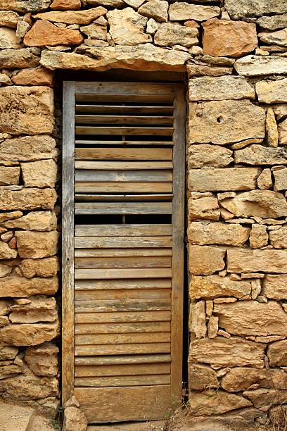 istock aged wood door on masonry stone wall 498052136
