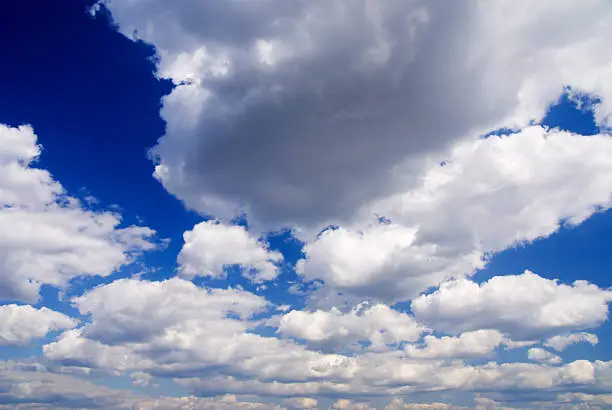 landscape of dramatic blue sky with fluffy clouds