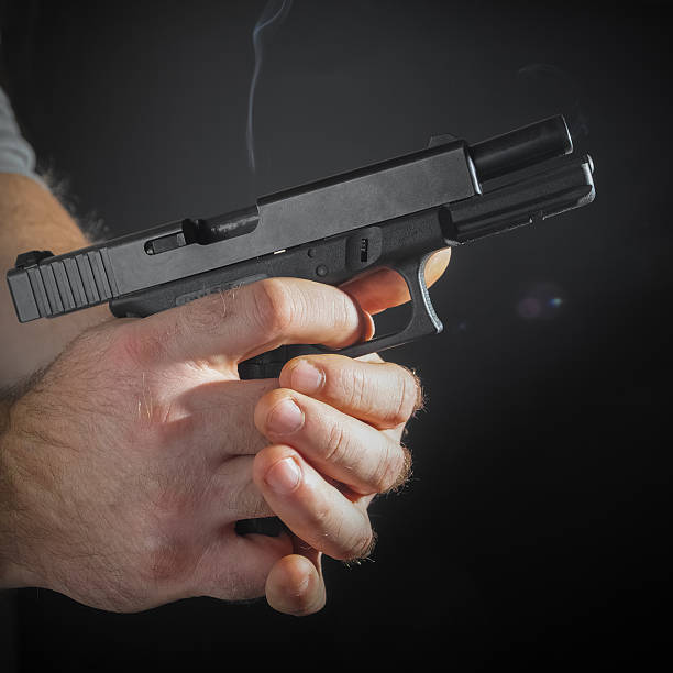 istock Male hand with a gun 498053880