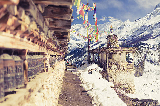 Prayer wheels in high Himalaya Mountains, Nepal village Prayer wheels in high Himalaya Mountains, Nepal village. Focus on the stupa and prayers flags. Annapurna Two range region in Nepal, located at Annapurna Circuit Trekking Hiking Trail annapurna circuit photos stock pictures, royalty-free photos & images