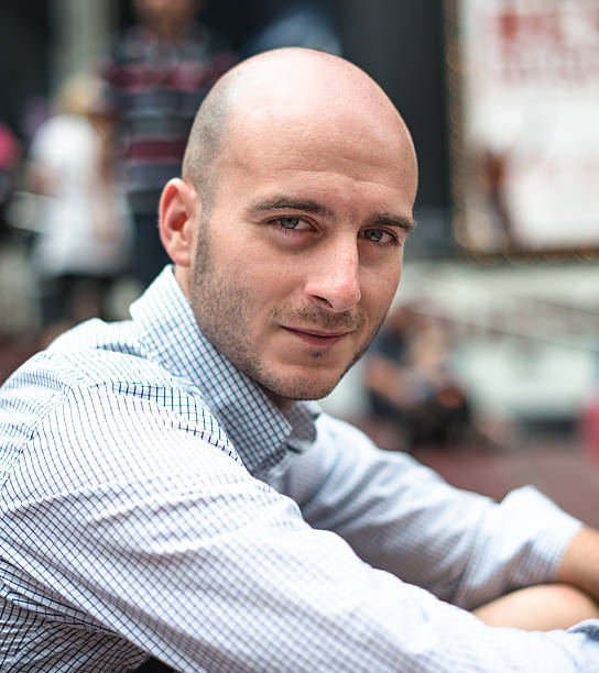 istock Smiling bald man sitting portrait 498058910
