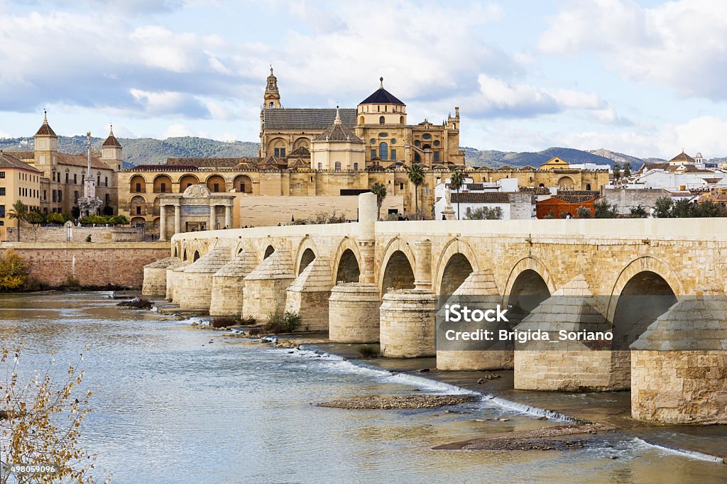 Roman Bridge and Mosque Cathedral of Cordoba in Spain Ancient Roman Bridge across the river Guadalquivir in Cordoba. Cordoba Mosque and Cathedral is in the background. This bridge was featured in TV series Game of Thrones as the Long Bridge of Volantis.. 2015 Stock Photo
