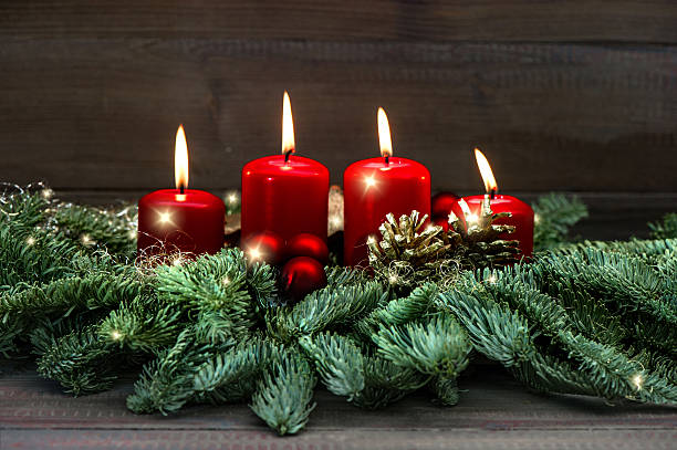istock Advent decoration wreath with four red burning candles 498060444