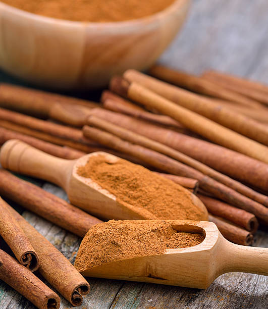 istock Cinnamon sticks and powder cinnamon in the bowl on table 498060630