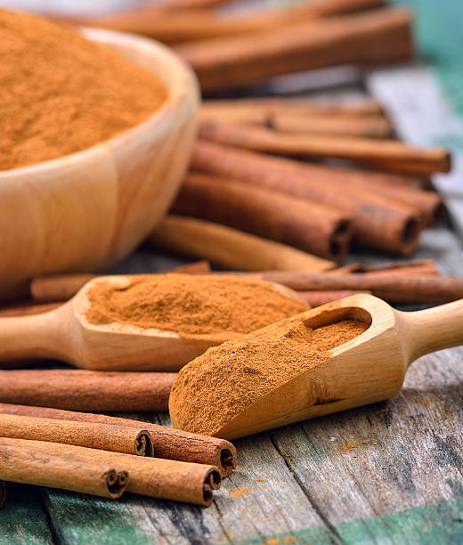 istock Cinnamon sticks and powder cinnamon in the bowl on table 498060808