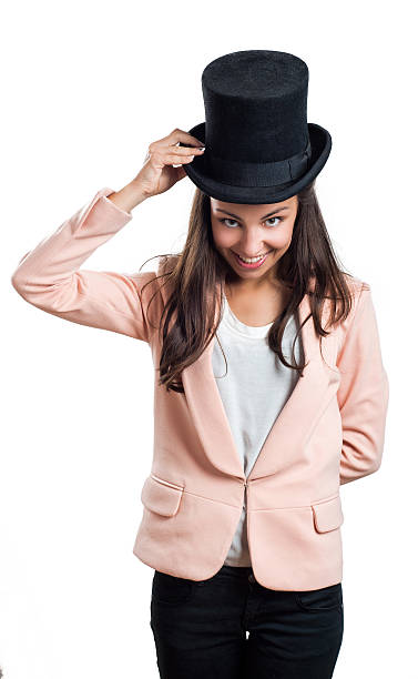 istock Girl holding hat with one hand isolated on white 498060898