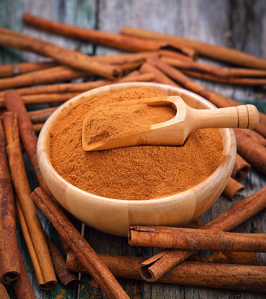 istock Cinnamon sticks and powder cinnamon in the bowl on table 498060938