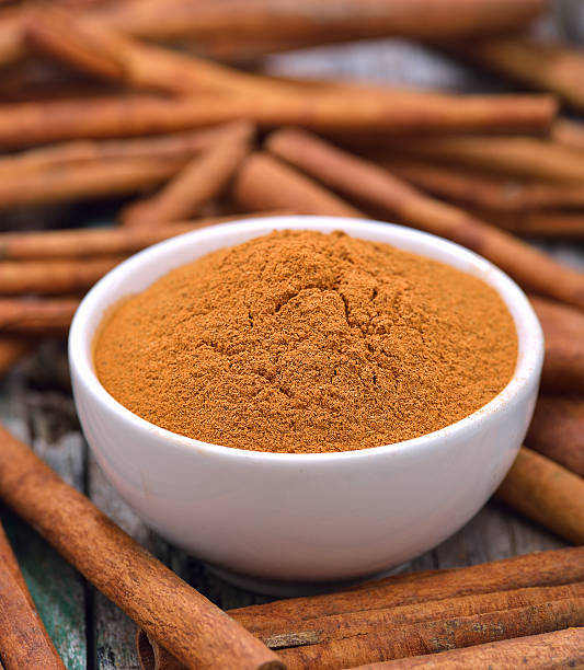 istock Cinnamon sticks and powder cinnamon in the bowl on table 498061040