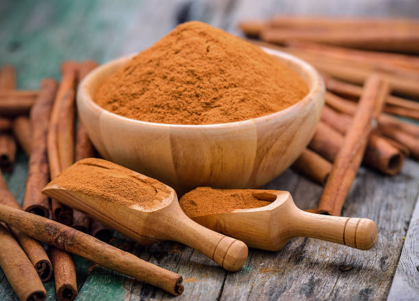 istock Cinnamon sticks and powder cinnamon in the bowl on table 498061144