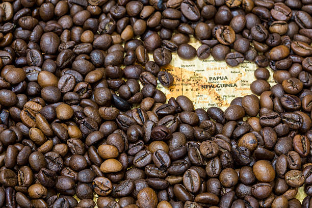 istock Map of Papua New Guinea under a coffee beans background 498063480