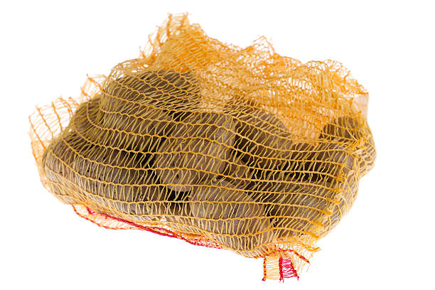 istock Ripe potatoes in burlap sack isolated on white background 498063915