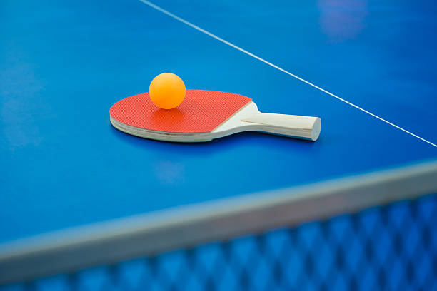 istock pingpong racket and ball & net on pingpong table vertical 498064230