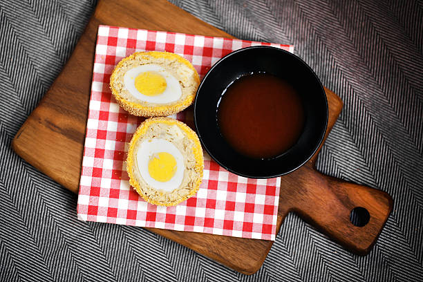 Scotch egg in meat and breaded with hot chili sauce stock photo