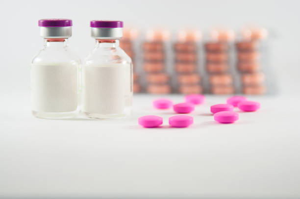 istock Pink tablet on medicine background 498066589