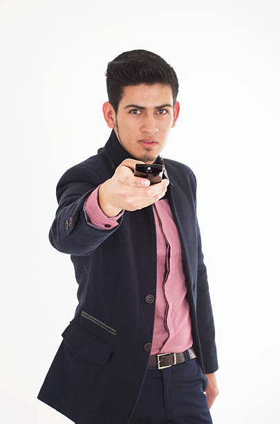istock man with tv remote control in a suit 498073315