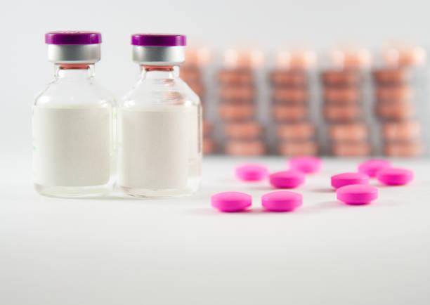 istock Pink tablet on medicine background 498074107