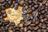 Map of Tanzania under a background of coffee beans