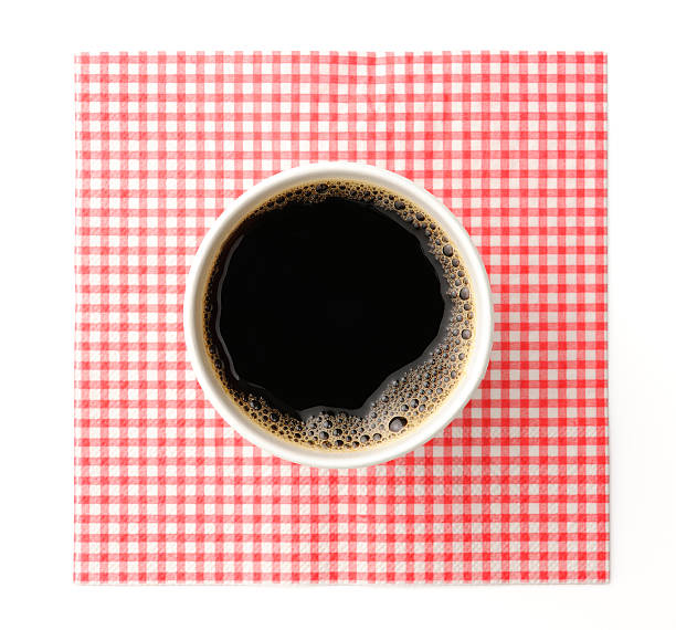 Black coffee in disposable cup with napkin on white background Overhead shot of black coffee in white disposable cup with mesh napkin, isolated on white background with clipping path. black coffee from above stock pictures, royalty-free photos & images