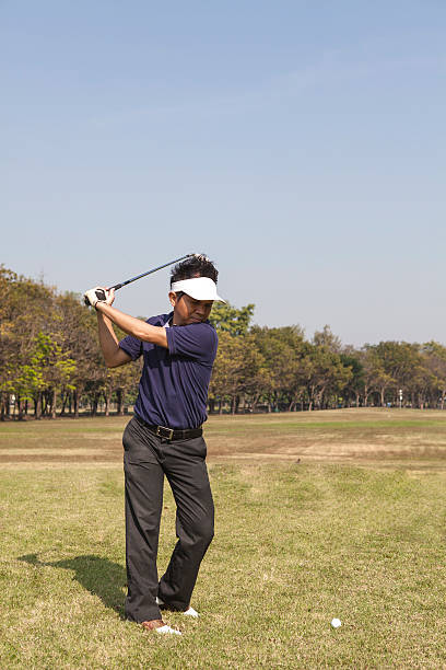 istock Male golfer swinging golf ball 498088215