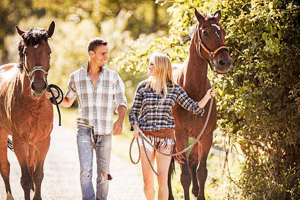 istock Couple with horses outdoors. 498089295