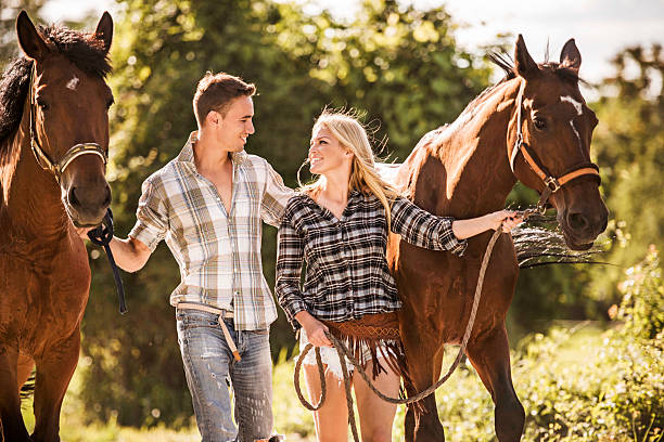 istock Smiling couple with horses. 498089349
