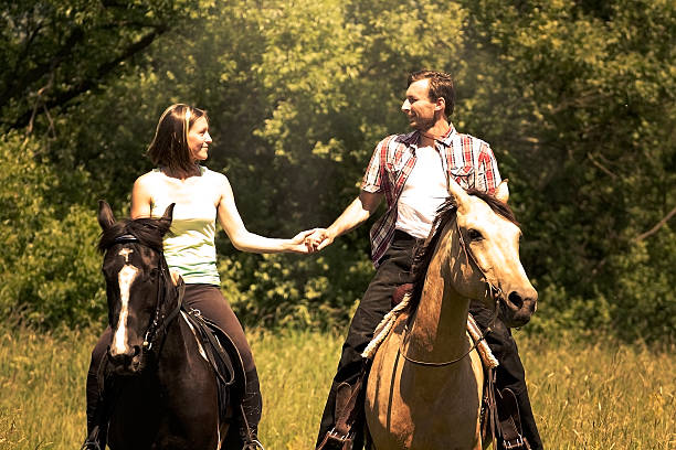 istock Young beautiful happy couple riding a horse 498089355