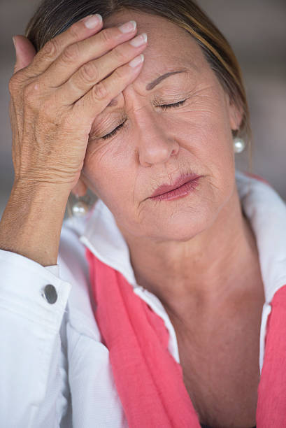 istock Woman with migraine headache closed eyes 498089912