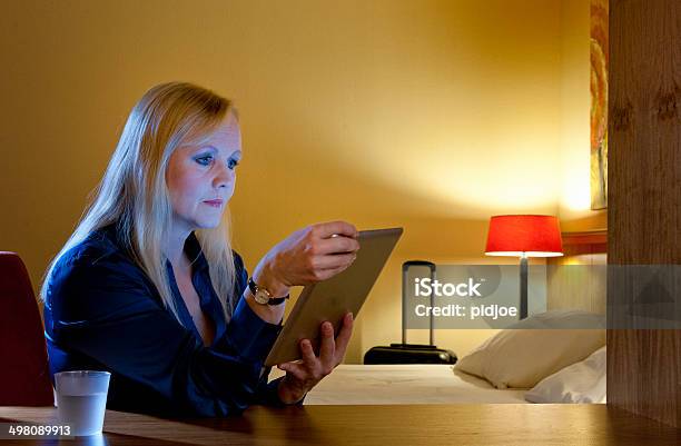 Woman Working In Hotel Room Using A Tabletpc Stock Photo - Download Image Now - 40-49 Years, Adult, Adults Only