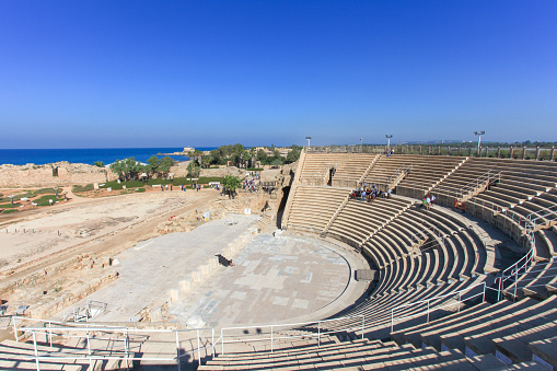 Caesarea, Israel - November 20, 2015: Tourists at the Famous Historical Roman amphitheater at Caesarea, Israel, built in the times of King Herodes. with people.