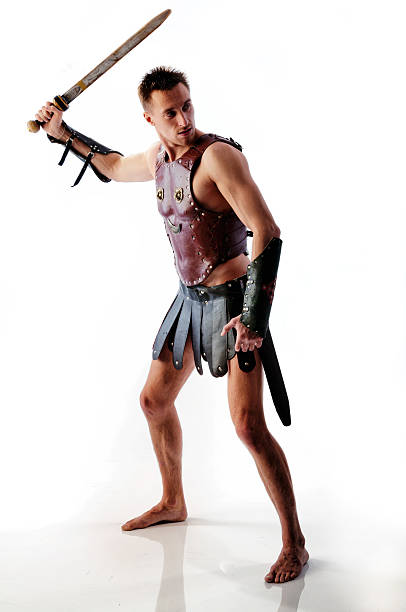 istock Ancient armed gladiator soldier with sword in battle pose isolated 498092489