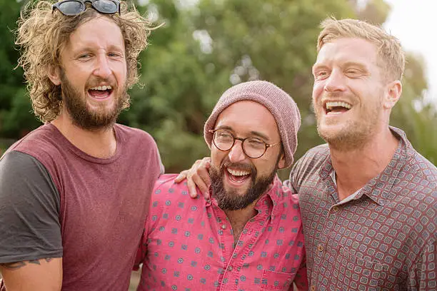 Best friends, small group of australian casual - fashionable men having fun. Laughing, talking, making jokes at an outdoor party. Sydney, Australia. Made with Sony 7RII, 42MPixel.